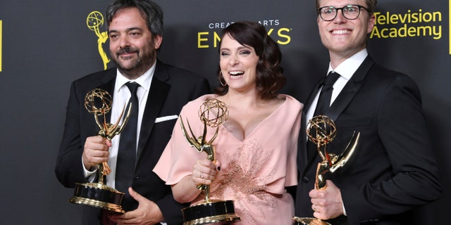 FILE - This Sept. 14, 2019 file photo shows Adam Schlesinger, from left, Rachel Bloom and Jack Dolgen in the press room with the awards for outstanding original music and lyrics for 'Crazy Ex Girlfriend' at the Creative Arts Emmy Awards in Los Angeles. 