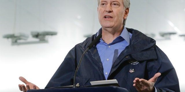 New York City Mayor Bill de Blasio speaks at the USTA Indoor Training Center where a 350-bed temporary hospital will be built Tuesday, March 31, 2020, in New York. The new coronavirus causes mild or moderate symptoms for most people, but for some, especially older adults and people with existing health problems, it can cause more severe illness or death. (AP Photo/Frank Franklin II)