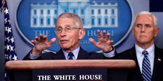 Dr. Anthony Fauci, director of the National Institute of Allergy and Infectious Diseases, speaks about the coronavirus at the White House, April 1, 2020, as Vice President Mike Pence listens. (Associated Press)