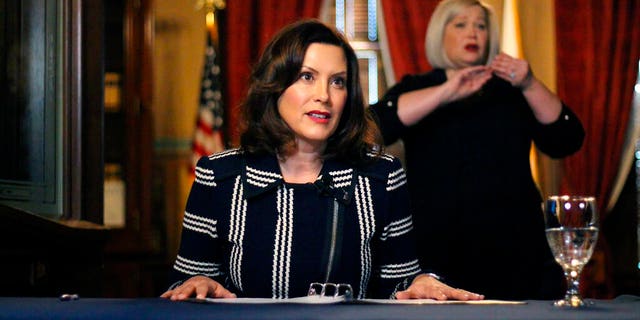 In this photo provided by the Michigan Office of the Governor, Michigan Gov. Gretchen Whitmer addresses the state during a speech in Lansing, Mich., Thursday, April 2, 2020. The governor ordered that students in the state will not return to K-12 school buildings the rest of the academic year due to the coronavirus pandemic and instead will learn remotely. All public and private schools are more than halfway through a four-week shutdown ordered by Whitmer to combat the outbreak. (Michigan Office of the Governor via AP)