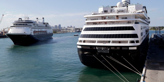 Holland America's cruise ship Rotterdam, left, arrives at Port Everglades as the Zaandam, right, is docked during the new coronavirus pandemic on April 2 in Fort Lauderdale, Fla. (AP Photo/Lynne Sladky)