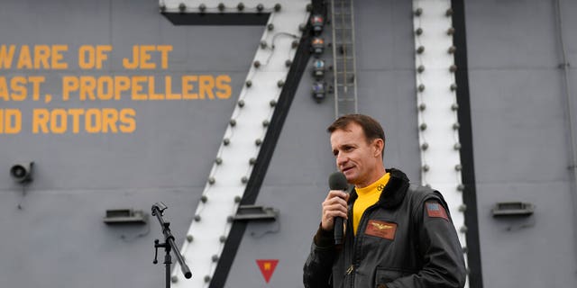 In this Nov. 15, 2019, photo U.S. Navy Capt. Brett Crozier, commanding officer of the aircraft carrier USS Theodore Roosevelt (CVN 71), addresses the crew during an all-hands call on the ship's flight deck while conducting routine operations in the Eastern Pacific Ocean. (U.S. Navy Photo by Mass Communication Specialist 3rd Class Nicholas Huynh via AP)
