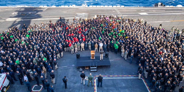 FILE - In this Dec. 15, 2019, file photo, U.S.Navy Capt. Brett Crozier, commanding officer of the aircraft carrier USS Theodore Roosevelt (CVN 71), addresses the crew during an all hands call on the ship's flight deck while conducting routine training in the Eastern Pacific Ocean.. (U.S. Navy Photo by Mass Communication Specialist Seaman Kaylianna Genier via AP)