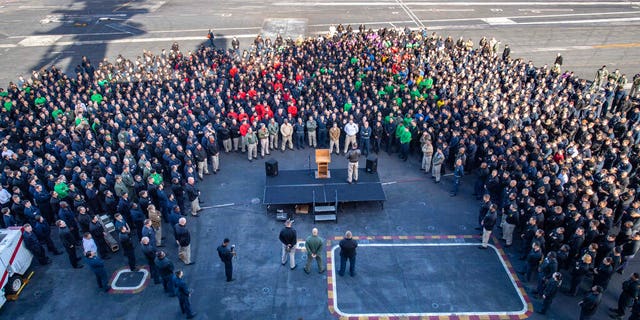 FILE - In this Dec. 15, 2019, file photo, U.S.Navy Capt. Brett Crozier, commanding officer of the aircraft carrier USS Theodore Roosevelt (CVN 71), addresses the crew during an all hands call on the ship's flight deck while conducting routine training in the Eastern Pacific Ocean.. (U.S. Navy Photo by Mass Communication Specialist Seaman Kaylianna Genier via AP)