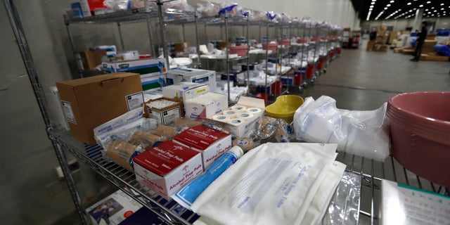 Closeup of a medical supply shelf at the TCF Center, Monday, April 6, 2020, in Detroit. The city's convention center was converted to accommodate an overflow of patients with the coronavirus. More than 2,200 employees at two major health systems in Michigan have either tested positive for the novel coronavirus or have symptoms, according to multiple reports on Monday. (AP Photo/Carlos Osorio)