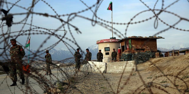 Afghan National Army soldiers stand guard at a checkpoint near the Bagram base in northern Kabul, Afghanistan, Wednesday, April 8, 2020. (AP Photo/Rahmat Gul)