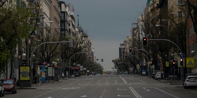 An empty street as the lockdown continues to combat the spread of coronavirus in downtown Madrid, Spain, Thursday. The new coronavirus causes mild or moderate symptoms for most people, but for some, especially older adults and people with existing health problems, it can cause more severe illness or death. (AP Photo/Manu Fernandez)