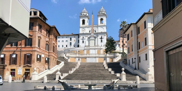 A view of the empty Piazza di Spagna, at the foot of the Spanish Steps, following the coronavirus lockdown measures, in Rome, Thursday. The new coronavirus causes mild or moderate symptoms for most people, but for some, especially older adults and people with existing health problems, it can cause more severe illness or death. (AP Photo/Karl Ritter)