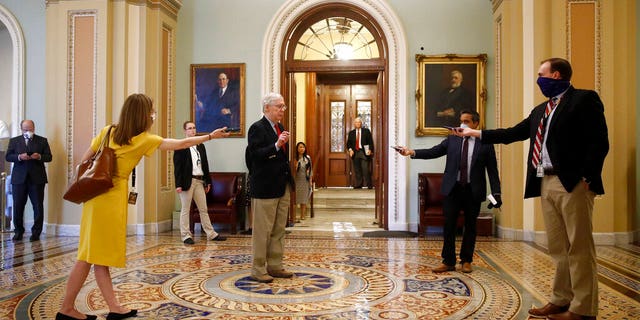 Senate Majority Leader Mitch McConnell of Ky., center, speaks with reporters outside the Senate chamber on Capitol Hill in Washington, Thursday, April 9, 2020. Senate Democrats on Thursday stalled President Donald Trump's request for $250 billion to supplement a 