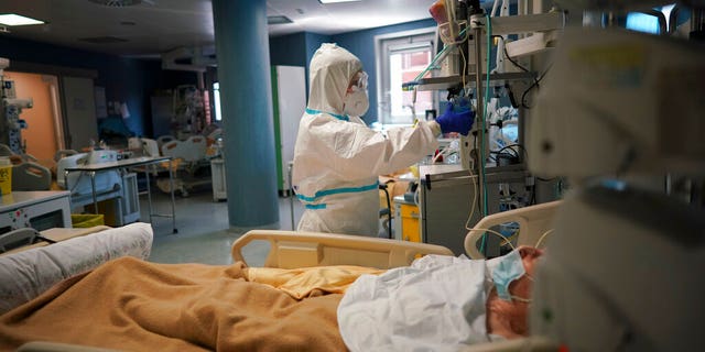 Medical staff tends to a patient in the ICU unit of Rome's San Filippo Neri Hospital's Covid department, in Rome, Thursday, April 9, 2020.