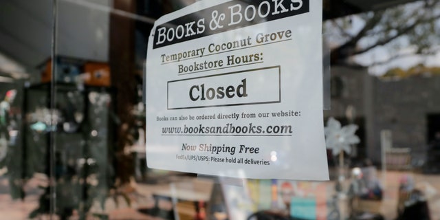 US overtakes Italy to have highest coronavirus death toll in the world after 2,000 deaths in a day 6 A sign on locally owned business Books & Books says the store is closed during the coronavirus pandemic, Thursday, April 9, 2020, in Miami. With 6.6 million people seeking unemployment benefits last week, the United States has reached a grim landmark: roughly one in 10 workers have lost their jobs in just the past three weeks to the coronavirus outbreak. (AP Photo/Lynne Sladky)