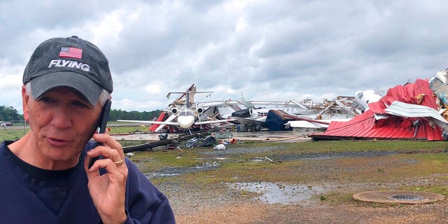 Rep. Ralph Abraham seen talking on his phone in front of a destroyed hangar and damaged planes at Monroe Regional Airport in Monroe, La.