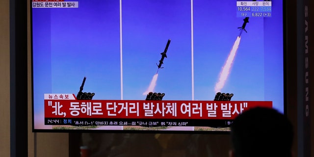 People watch a TV screen airing reports about North Korea's firing missiles with file images of missiles at the Seoul Railway Station in Seoul, South Korea, Tuesday, April 14, 2020. South Korea says North Korean fighter jets have fired missiles off the North's east coast. \(AP Photo/Lee Jin-man)