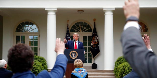 President Donald Trump takes questions from reporters as he speaks about the coronavirus in the Rose Garden of the White House, Tuesday, April 14, 2020, in Washington. (AP Photo/Alex Brandon)