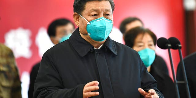 In this Tuesday, March 10, 2020, photo released by China's Xinhua News Agency, Chinese President Xi Jinping talks by video with patients and medical workers at the Huoshenshan Hospital in Wuhan in central China's Hubei Province. (Xie Huanchi/Xinhua via AP)