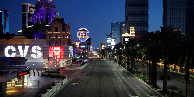 The Las Vegas Strip is deserted on April 14, as casinos and other businesses are closed because of the coronavirus outbreak.  (AP Photo/John Locher)
