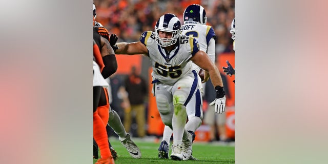 Los Angeles Rams center Brian Allen blocks during the second half of an NFL football game against the Cleveland Browns in Cleveland last September. Allen said Wednesday that he tested positive for COVID-19 three weeks ago. Allen is the first active NFL player to acknowledge testing positive during the coronavirus pandemic. (AP Photo/David Dermer)