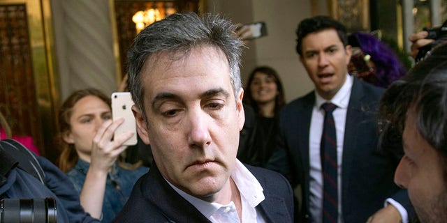 In this May 6, 2019, file photo, Michael Cohen, former attorney to President Donald Trump, leaves his apartment building before beginning his prison term in New York. (AP Photo/Kevin Hagen, File)