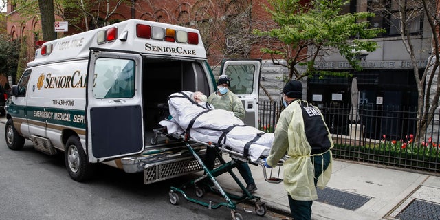 A patient is loaded into the back of an ambulance by emergency medical workers outside Cobble Hill Health Center, Friday, April 17, 2020, in the Brooklyn borough of New York.