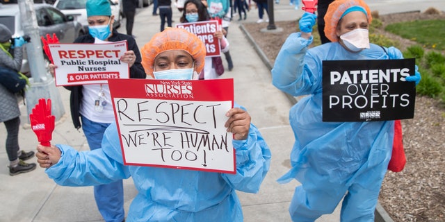 Nurses hold a demonstration outside Jacobi Medical Center to protest a new policy by the hospital requiring a doctor's note for paid sick leave, April 17 in the Bronx borough of New York. The head of the emergency department at a Manhattan hospital committed suicide after spending days on the front lines of the coronavirus battle, her family said Monday. (AP Photo/Mary Altaffer)