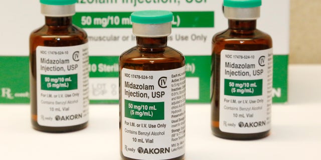 This July 25, 2014 file photo shows bottles of the sedative midazolam at a hospital pharmacy in Oklahoma City. Many of the medications being used to sedate and paralyze COVID-19 patients placed on ventilators and to also treat their pain are the same drugs that put inmates to death by lethal injection. Last month, nationwide demand for these drugs surged 73 percent during the pandemic.