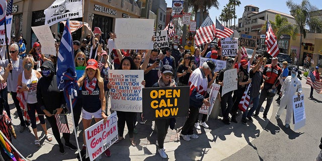 Protesters demonstrate against stay-at-home orders that were put in place due to the COVID-19 outbreak, Friday, April 17, 2020, in Huntington Beach, Calif. (Associated Press)