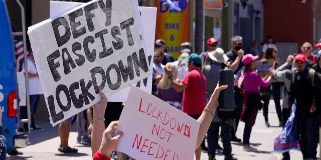 Protesters demonstrate against stay-at-home orders that were put in place due to the COVID-19 outbreak, Friday, April 17, 2020, in Huntington Beach, Calif. (Associated Press)