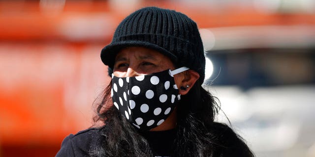 Jeanette Vizguerra wears a face mask during a car protest calling for the release of detainees at the GEO Immigration Detention Center because of the dangers posed by the new coronavirus Friday, April 17, 2020, in Denver. (AP Photo/David Zalubowski)