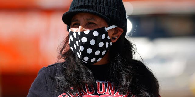 Jeanette Vizguerra wears a face mask during a car protest calling for the release of detainees at the GEO Immigration Detention Center because of the dangers posed by the new coronavirus Friday, April 17, 2020, in Denver. (AP Photo/David Zalubowski)