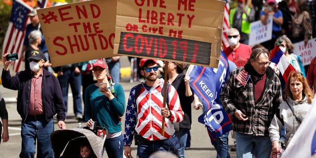 Demonstrators at a protest opposing Washington state's stay-home order to slow the coronavirus outbreak Sunday in Olympia, Wash.  (AP Photo/Elaine Thompson)