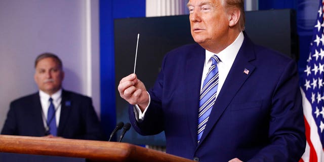 President Trump holdinng a swab that could be used in coronavirus testing, during the White House coronavirus briefing Sunday. (AP Photo/Patrick Semansky)