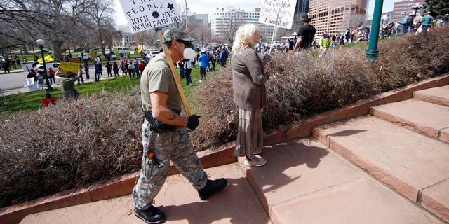 Protesters against restrictions issued by Colorado Gov. Jared Polis, in Denver on Sunday. (AP Photo/David Zalubowski)