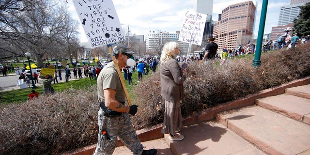 Protesters against restrictions issued by Colorado Gov. Jared Polis, in Denver on Sunday. (AP Photo/David Zalubowski)