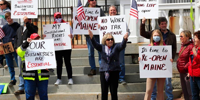 Anti-stay-at-home demonstrators gather in front of the Blaine House, the governor's mansion, Monday, April 20, 2020, in Augusta, Maine. Maine now has 835 cases of coronavirus with a total of 35 deaths.