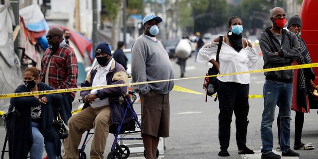 People line up to get tested for COVID-19 in the Skid Row district Monday, April 20 in Los Angeles. The coronavirus outbreak in Los Angeles County is believed to have infected an estimated 28 to 55 times more people than originally thought, according to a report on Monday. (AP Photo/Marcio Jose Sanchez)