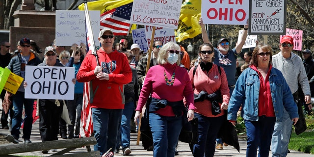 Protesters gather outside of the Ohio State House in Columbus, Ohio, Monday, April 20, 2020, to protest the stay home order that is in effect until May 1. (AP Photo/Gene J. Puskar)