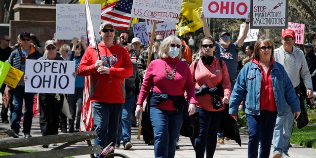 Protesters gather outside of the Ohio State House in Columbus, Ohio, Monday, April 20, 2020, to protest the stay home order that is in effect until May 1. (AP Photo/Gene J. Puskar)