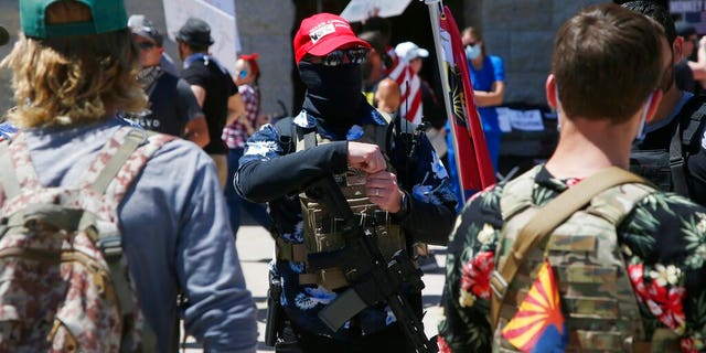 Protesters calling to 're-open' Arizona at a rally Monday in Phoenix.
