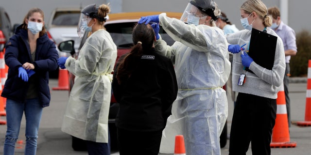 Medical staff test shoppers at a pop-up community COVID-19 testing station at a supermarket parking lot in Christchurch, New Zealand, on Friday. (AP)