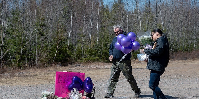 A memorial pays tribute to health-care worker Kristen Beaton along the highway in Debert, Nova Scotia, on Tuesday, April 21, 2020. (Andrew Vaughan/The Canadian Press via AP)