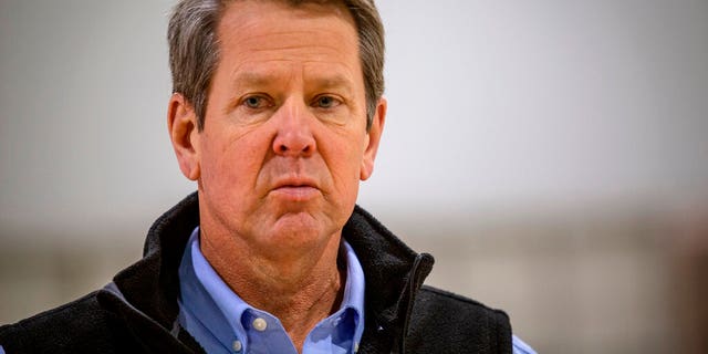 In this April 16, 2020, file photo, Georgia Gov. Brian Kemp listens to a question from the press during a tour of a temporary hospital at the Georgia World Congress Center in Atlanta.