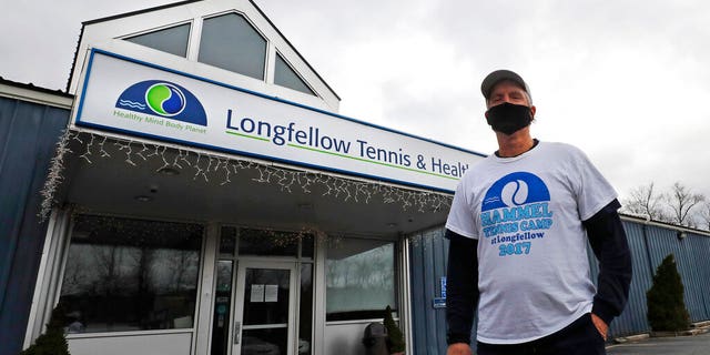 In this Tuesday April 21, 2020 photograph, Laury Hammel, CEO and founder of the Longfellow Health Clubs and the Salt Lake Tennis and Health Club, poses at the Wayland, Mass. facility, closed due state COVID-19 restrictions.