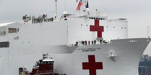In this March 30, 2020 file photo, the U.S. Navy hospital ship USNS Comfort is escorted up the Hudson River on its way to New York City. On Tuesday, April 21, 2020, while expressing confidence that stresses on New York City’s hospital system are easing, New York Gov. Andrew Cuomo said that the ship deployed to New York City to help fight the coronavirus outbreak is no longer needed. (AP Photo/Kathy Willens. File)