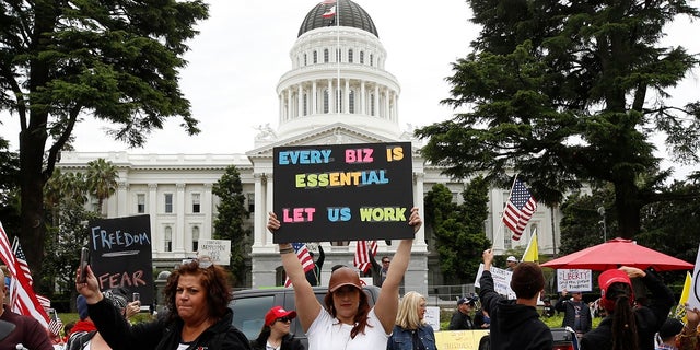 In this Monday, April 20, 2020, file photo, protesters calling for an end of Gov. Gavin Newsom's stay-at-home orders rally at the state Capitol in Sacramento, Calif. The California Highway Patrol announced on April 22 that it is temporarily banning rallies at the state Capitol and other state facilities due to the pandemic. (AP Photo/Rich Pedroncelli, File)