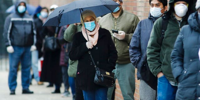 People line up at Gotham Health East New York, a COVID-19 testing center  April 23, in the Brooklyn borough of New York. 