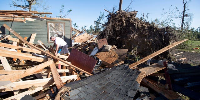 David Maynard sifts through the rubble searching for his wallet, Thursday, April 23, 2020 in Onalaska, Texas, after a tornado destroyed his home the night before. Maynard was inside his home when a tornado devastated the area. 