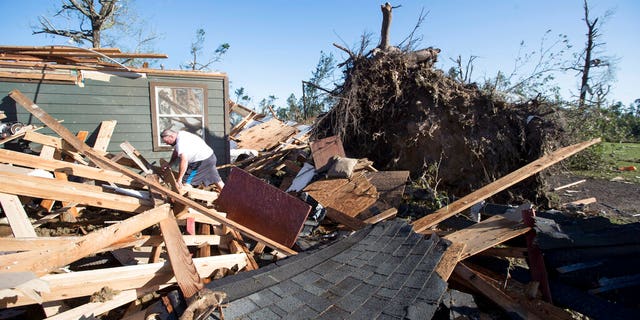 David Maynard sifts through the rubble searching for his wallet, Thursday, April 23, 2020 in Onalaska, Texas, after a tornado destroyed his home the night before. Maynard was inside his home when a tornado devastated the area.