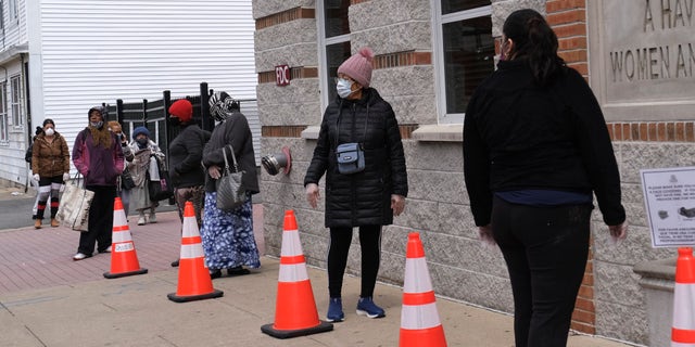 Women wait in line to receive food assistance at Oasis in Paterson, N.J., on April 23. (AP Photo/Seth Wenig)