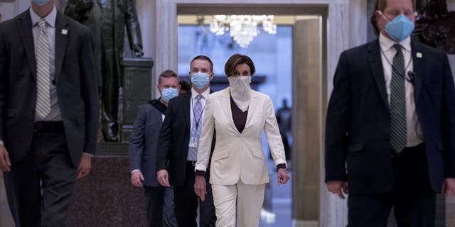 House Speaker Nancy Pelosi of Calif. walks to the House Chamber to vote on the nearly $500 billion Coronavirus relief bill on Capitol Hill, Thursday, April 23, 2020, in Washington. (AP Photo/Andrew Harnik)