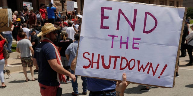 Ignoring social distancing and mandates to wear masks for other face coverings, protesters attend an "Open Texas" rally at the Texas State Capitol, Saturday, April 25, 2020, in Austin, Texas. Due to the COVID-19 pandemic, Texas is under stay-at-home orders except for essential workers and businesses.
